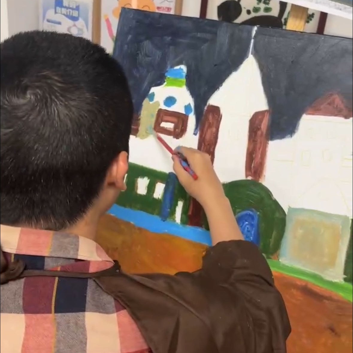 A member painting a building in oils, brush in hand