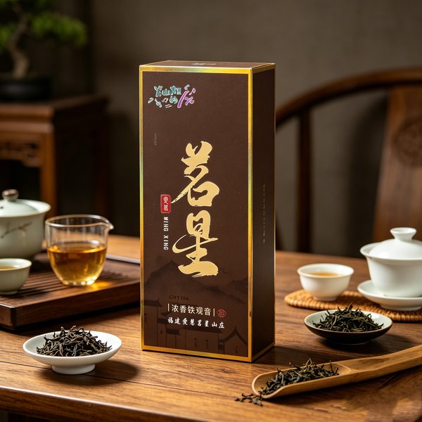 A tall dark brown box edged in gold and lettered 茗星 in gold, standing on a wooden tea table beside a glass of amber tea and dishes of dry leaf