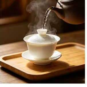 Boiling water being poured into a gaiwan to warm it