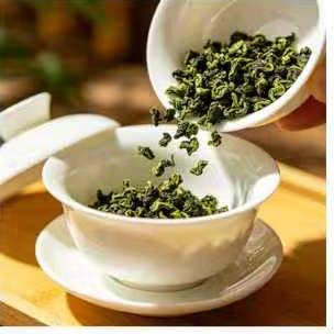 Dry Tieguanyin leaves being placed into a gaiwan
