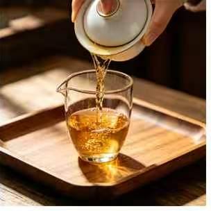Tea being poured from the gaiwan into the fairness pitcher